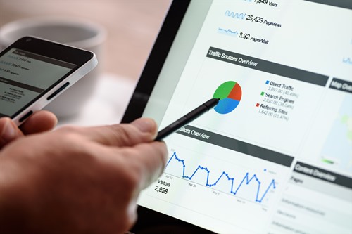 Tablet showing marketing analysis charts on a work desk